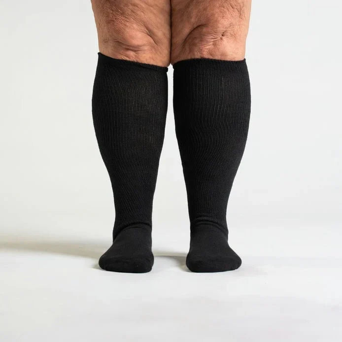 Black unisex circulation socks, side view, showing ankle and arch support features.