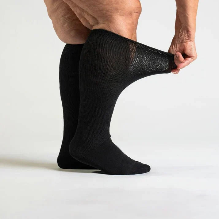 Comfortable black compression socks for improved circulation, folded neatly on a flat surface.