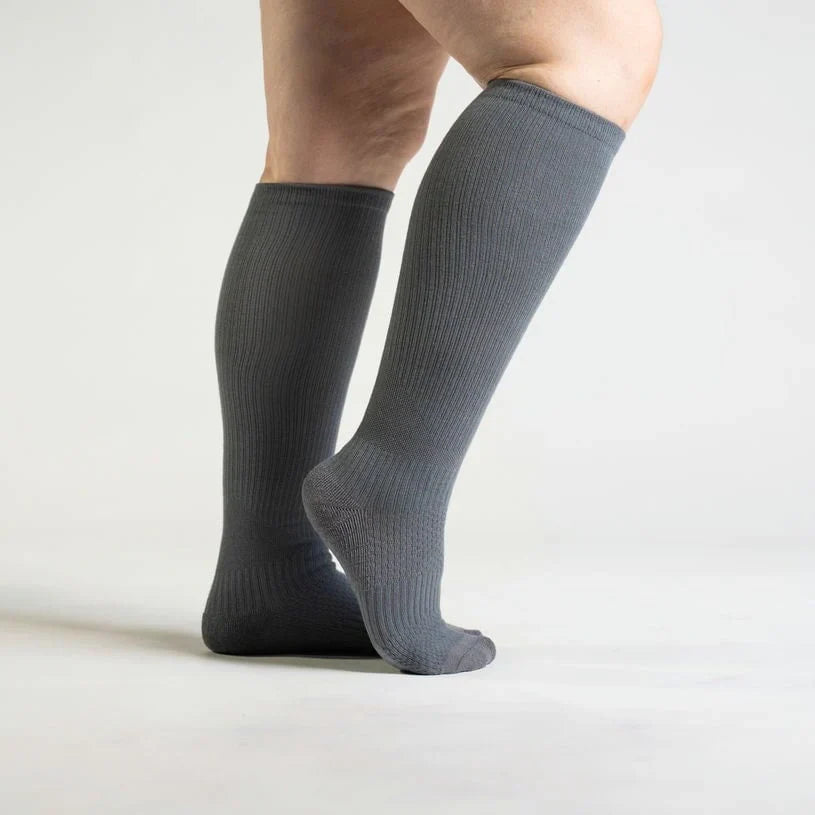 Unisex gentle compression socks in a soft gray color, designed for comfort and wellness.