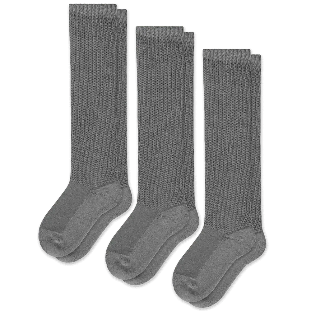 A person wearing gray unisex gentle compression socks for all-day comfort and support.