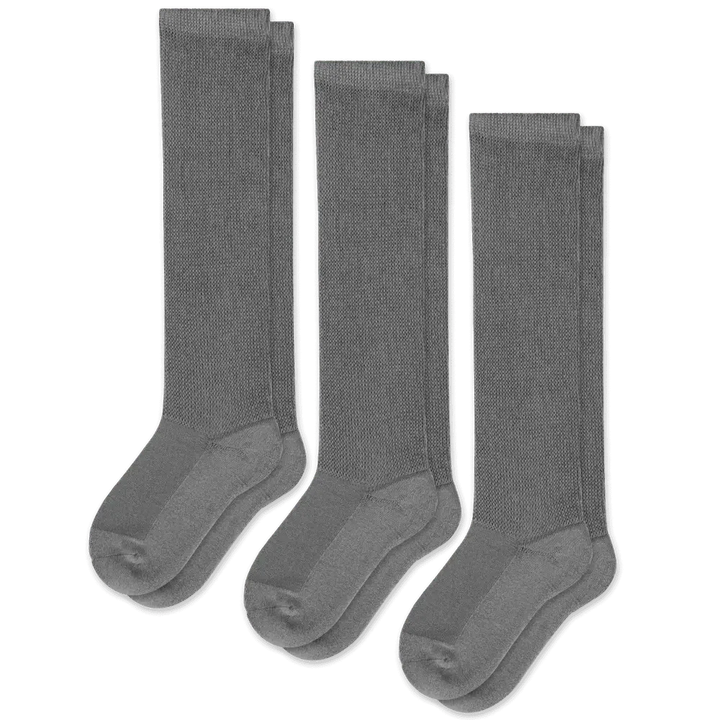 A person wearing gray unisex gentle compression socks for all-day comfort and support.