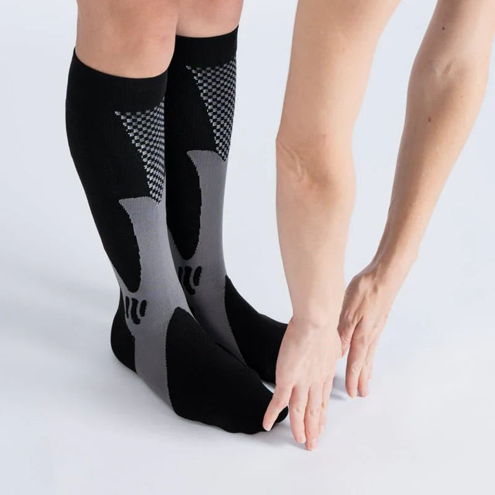 Unisex legs wearing midnight gray gentle compression socks, showing ankle and calf support