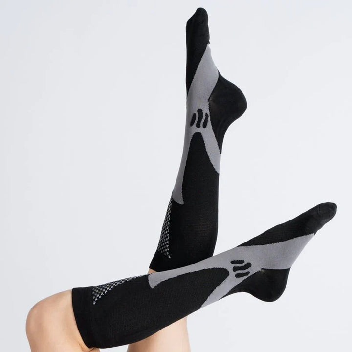 Studio shot of folded midnight gray compression socks, highlighting their versatile design and color
