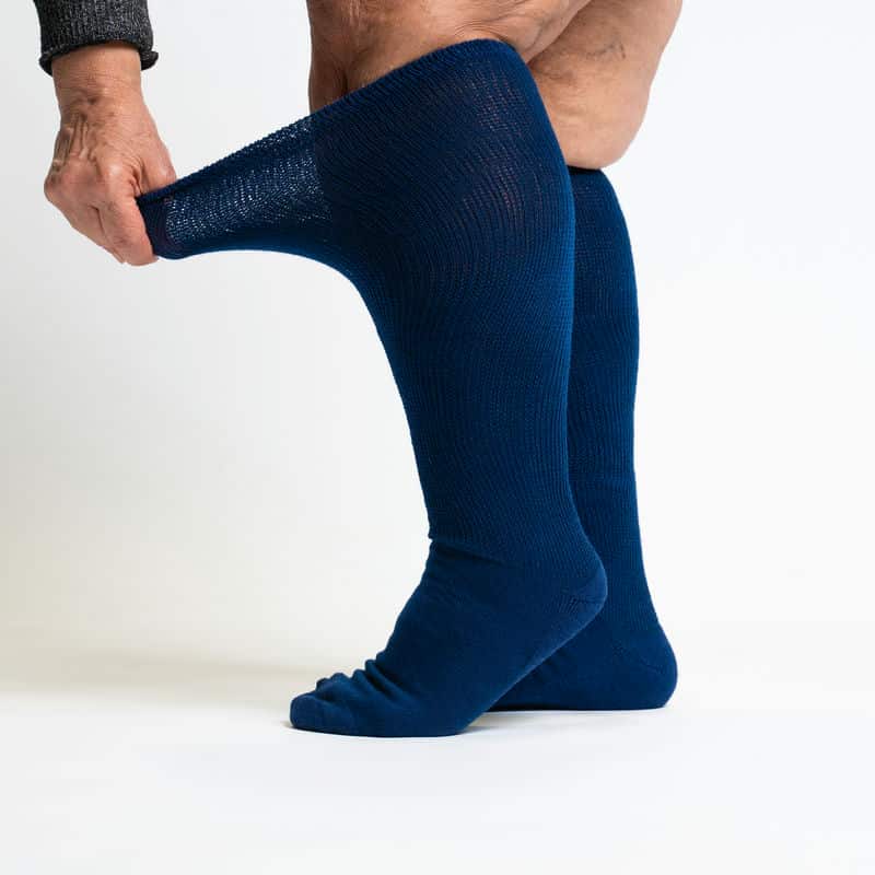 Two navy blue compression socks, designed to enhance blood circulation and provide leg support