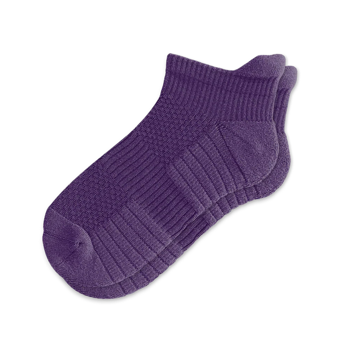 Pair of royal purple unisex ankle compression socks, isolated, for enhanced circulation and support.