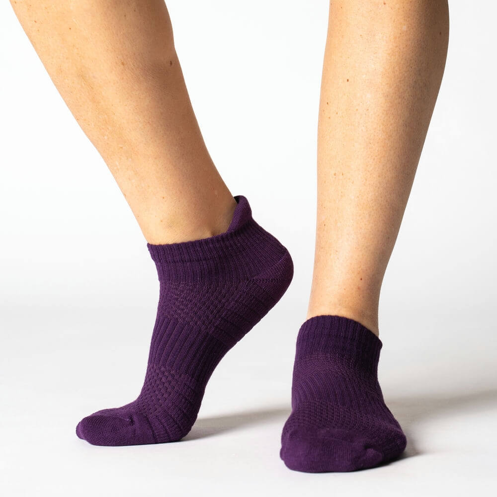 Royal purple compression ankle socks, neatly folded, highlighting vibrant color and fatigue relief benefits.