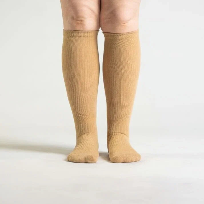 Pair of tan unisex gentle compression socks for comfortable support and improved leg circulation.
