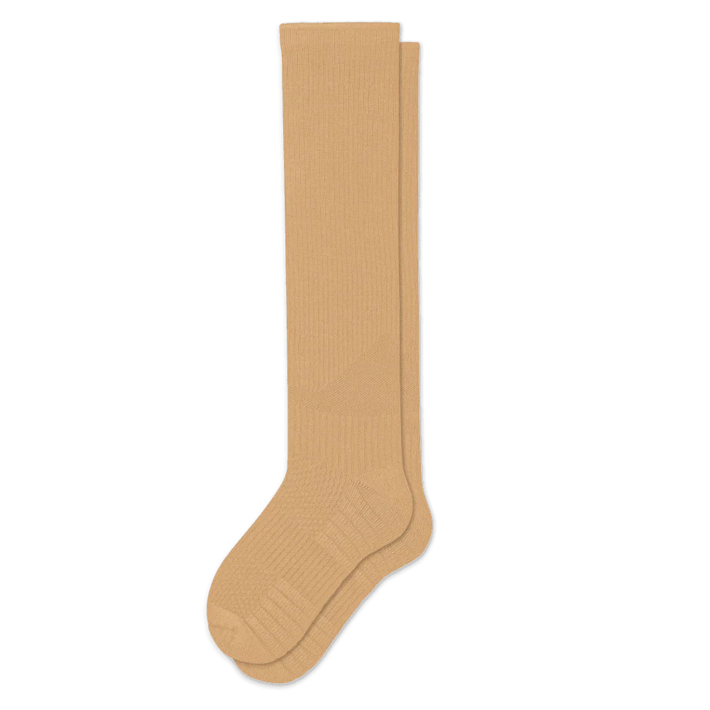 Tan gentle compression socks, unisex design, providing comfortable support for leg health and travel.