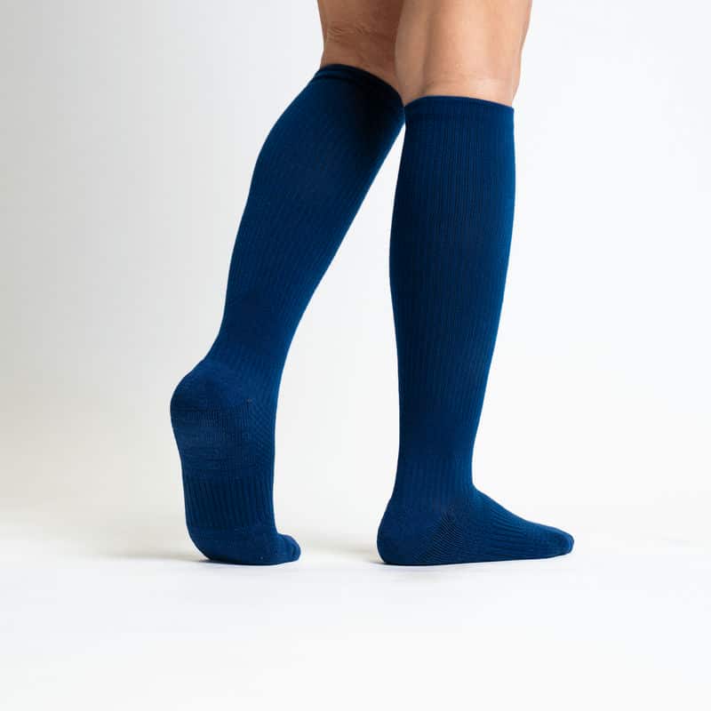 Model wearing navy blue gentle compression socks, showcasing their subtle and comfortable fit.