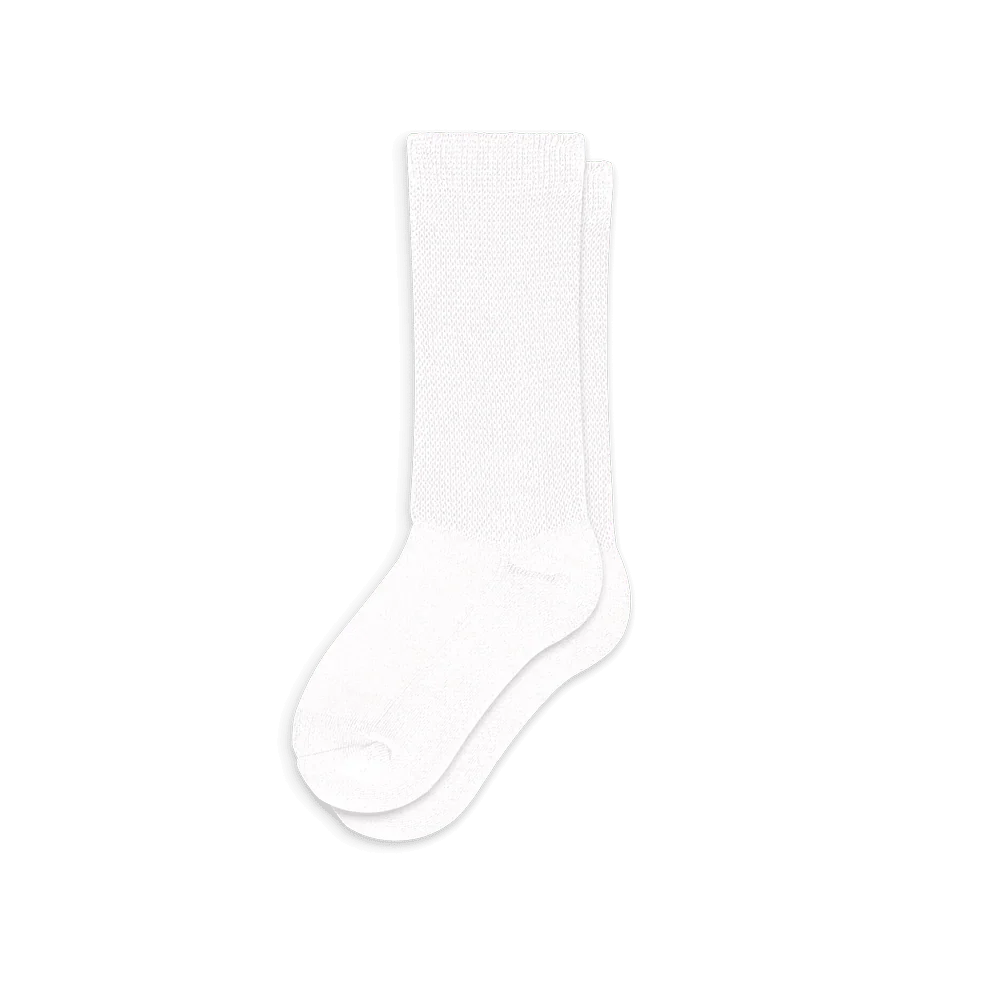 Multiple pairs of white comfort compression socks stacked, representing their availability for health and wellness.
