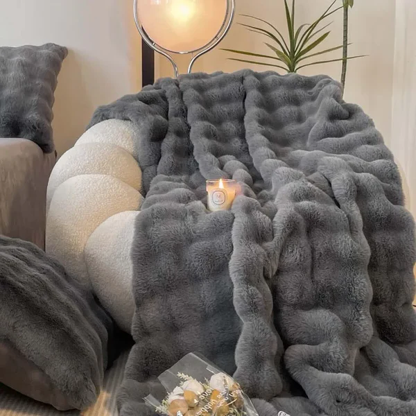 "Plush faux fur throw blanket in rich, elegant colors, ideal for winter warmth and stylish decor accents."