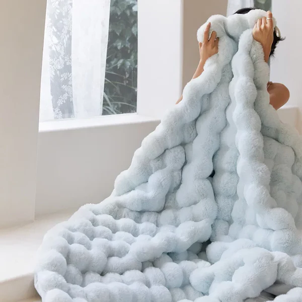 "Plush faux fur throw blanket in rich, elegant colors, ideal for winter warmth and stylish decor accents."
