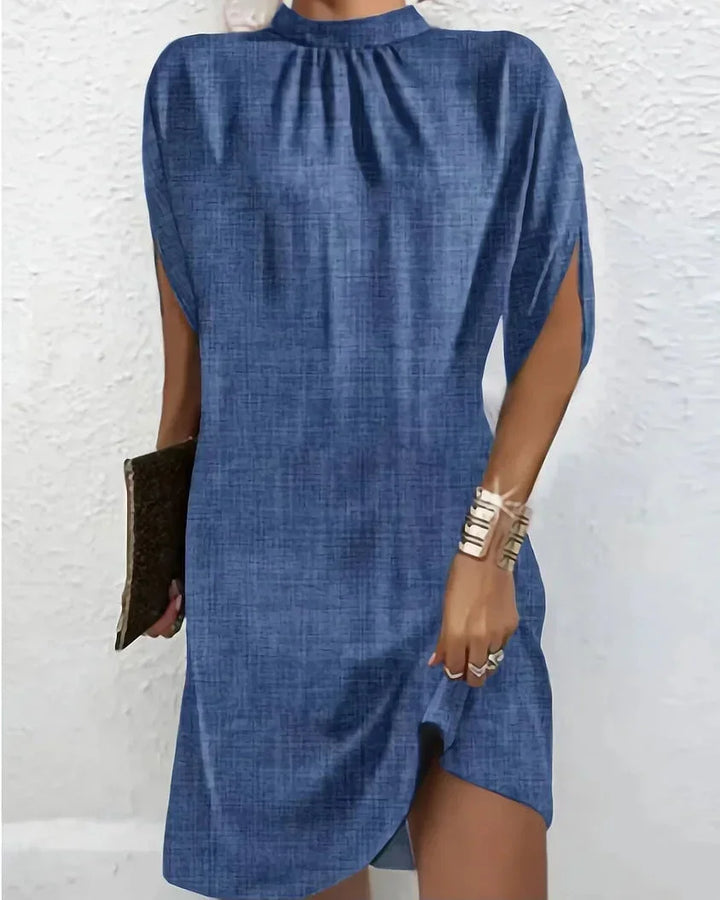 Party-ready women's dress: mock neck, mini length, and elegant cape sleeves.