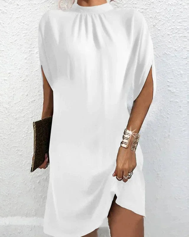 Women's fashion mini dress with a statement mock neck and dramatic cape sleeves.