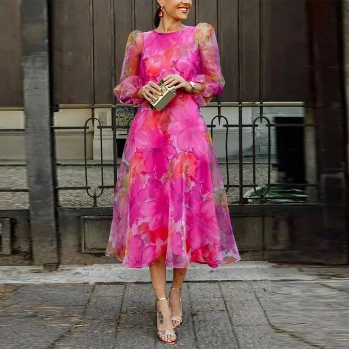Sophisticated women's floral midi dress with long sheer sleeves, ideal for wedding guests & parties.