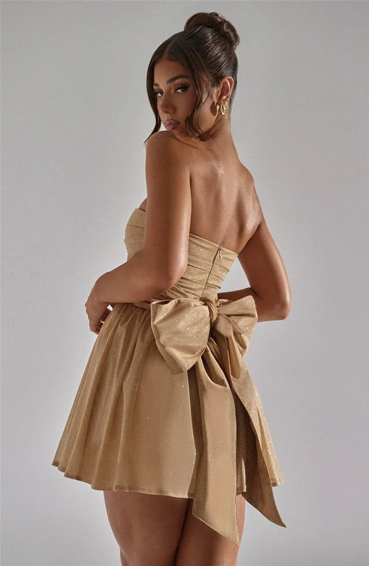 Glittering women's mini dress for parties. Fitted sparkling occasion wear, evening fashion.
