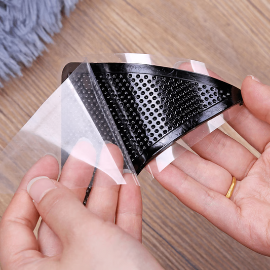 "Square non-slip rug gripper pads on light surface, self-adhesive and residue-free, ensuring rugs stay secure on all floors."