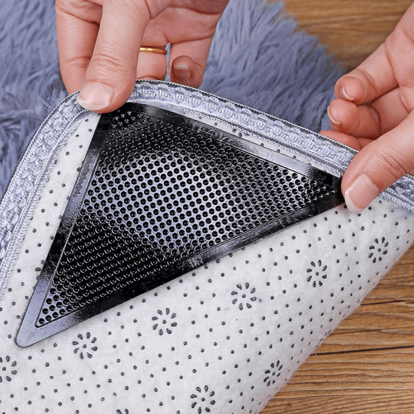 "Square non-slip rug gripper pads on light surface, self-adhesive and residue-free, ensuring rugs stay secure on all floors."