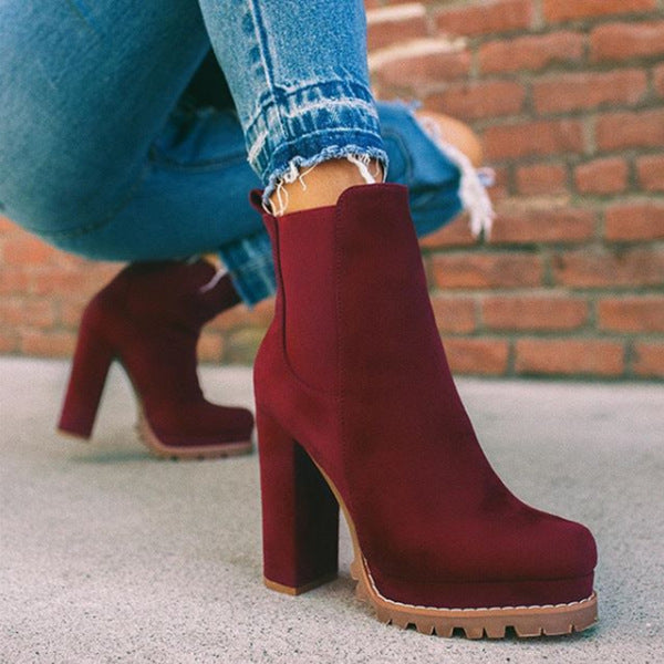 Chic slip-on women's ankle boots with platform & block heel, versatile for casual or evening wear.