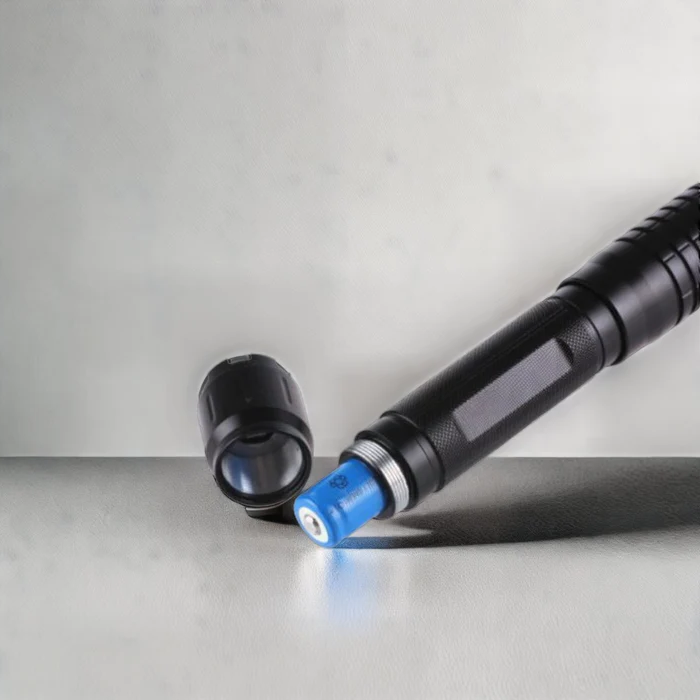 "Tactical laser torch emitting a bright blue beam, ideal for outdoor adventures and survival, made of sturdy aluminum."