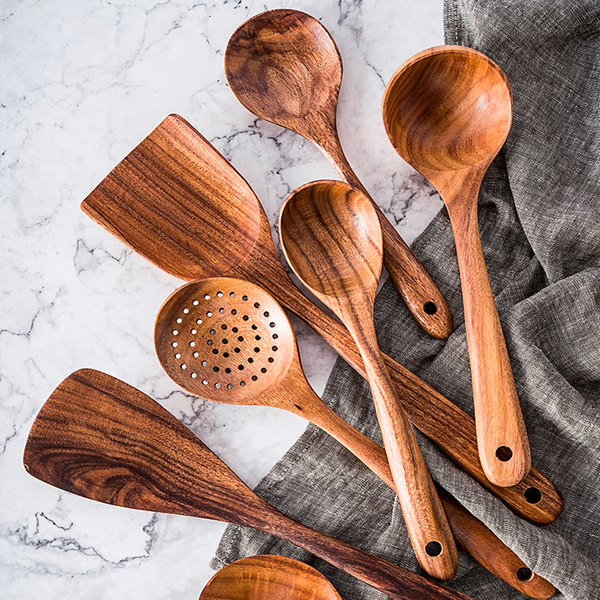"Teak wood kitchen utensils set, eco-friendly and non-toxic, showcasing natural grain, perfect for sustainable cooking."