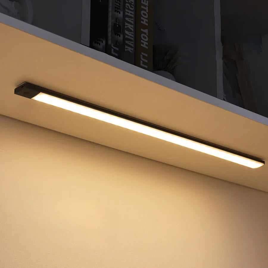 Ultra-slim motion sensor cabinet light in sleek aluminum, black or silver, 9mm thick, 20-60cm, versatile, hands-free.