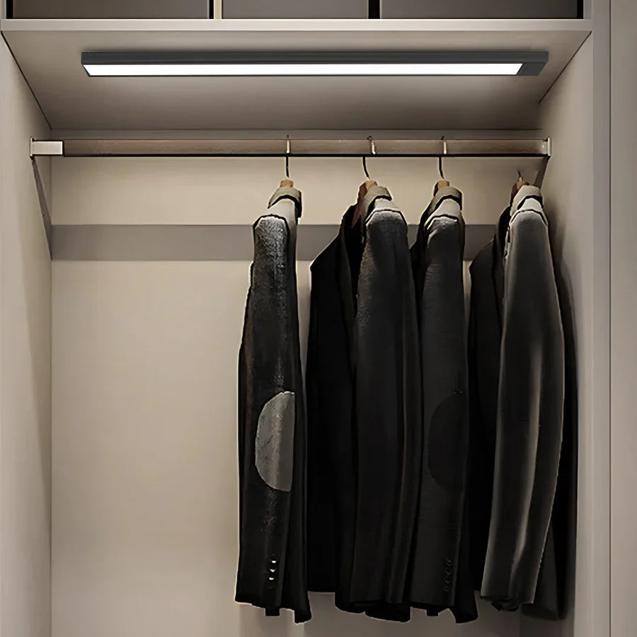 Ultra-slim motion sensor cabinet light in sleek aluminum, black or silver, 9mm thick, 20-60cm, versatile, hands-free.