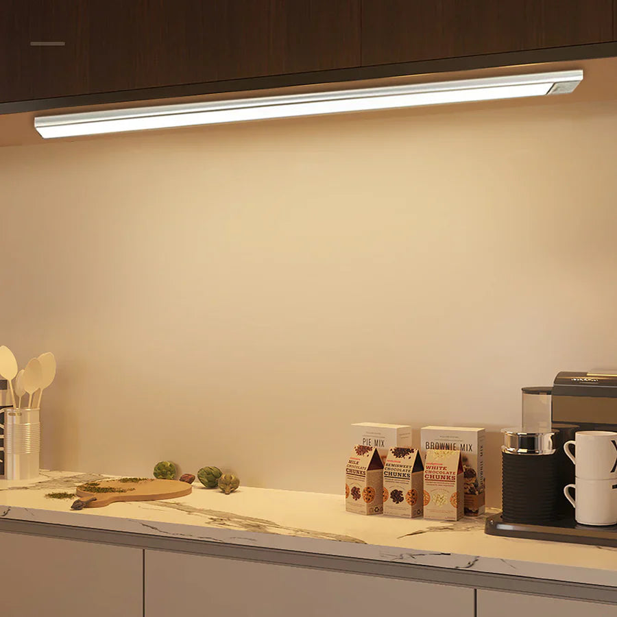 Ultra-slim motion sensor cabinet light in sleek aluminum, black or silver, 9mm thick, 20-60cm, versatile, hands-free.