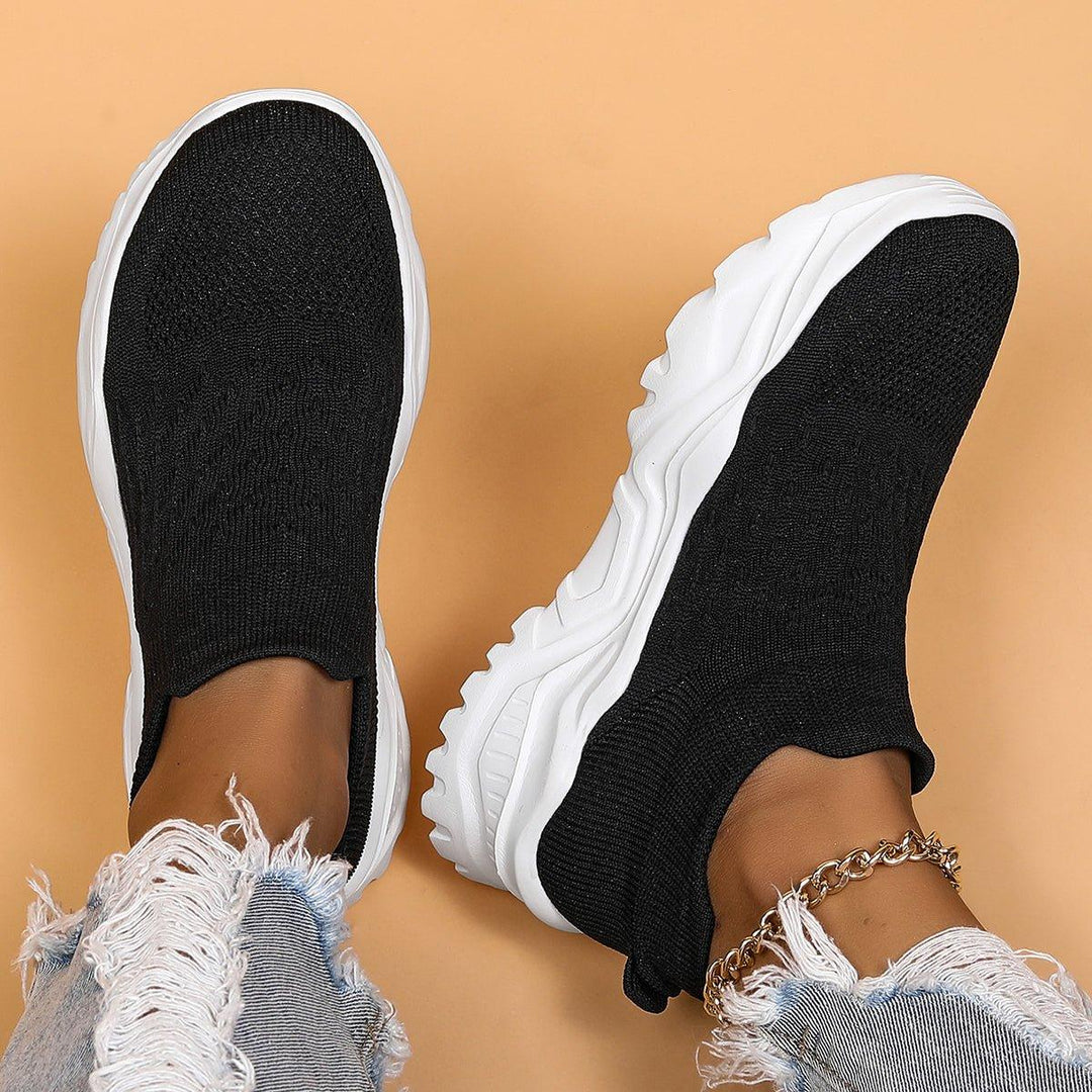 Black & white orthopedic slip-on shoes, offering comfort, support, and a casual look for men and women