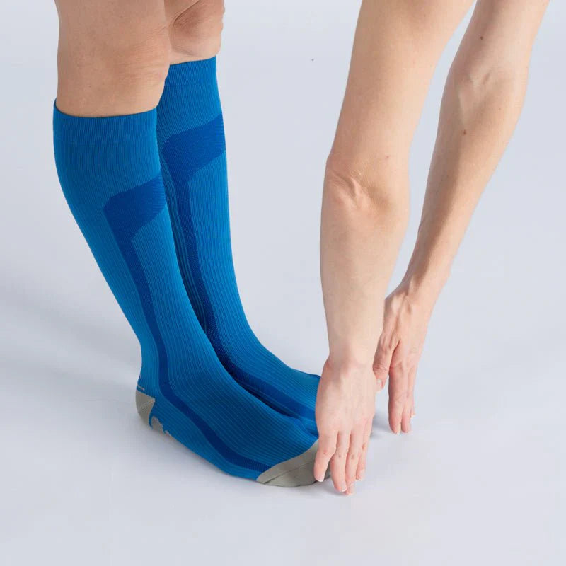 Model wearing blue gray gentle compression socks, showing full length for leg support and comfortable footwear.