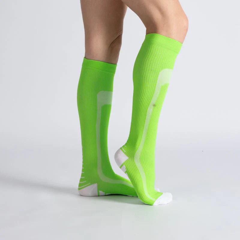 Pair of green and white unisex gentle compression socks, ideal for daily wear and improved leg circulation.
