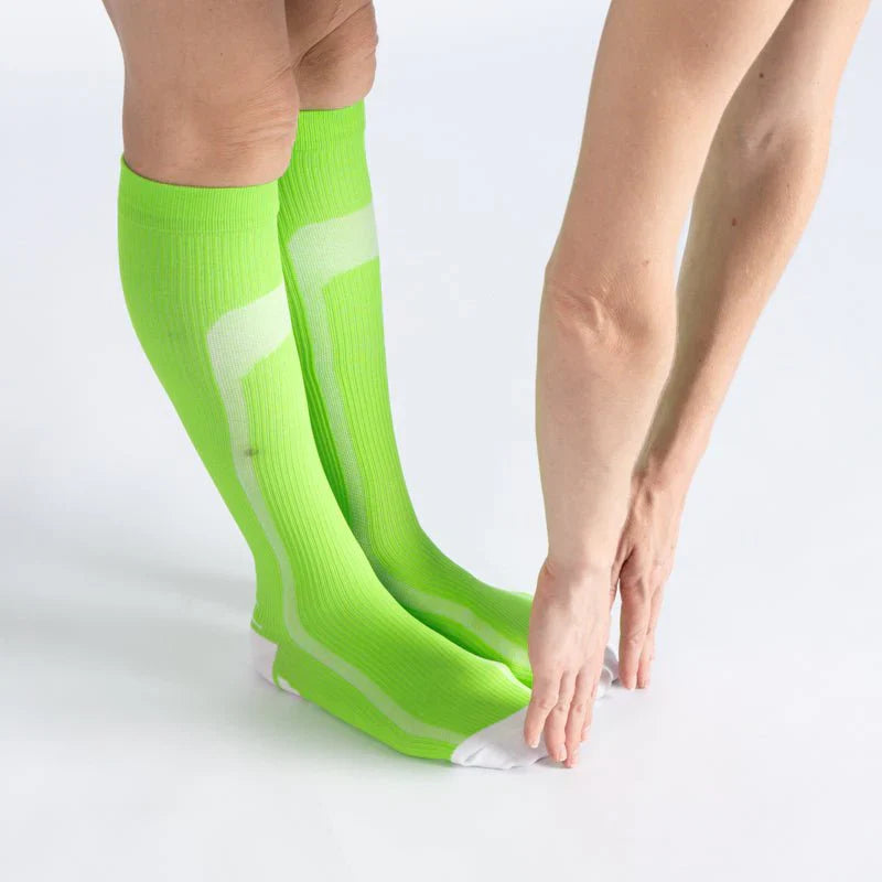 Comfortable green and white striped gentle compression socks for unisex use, offering subtle leg support.