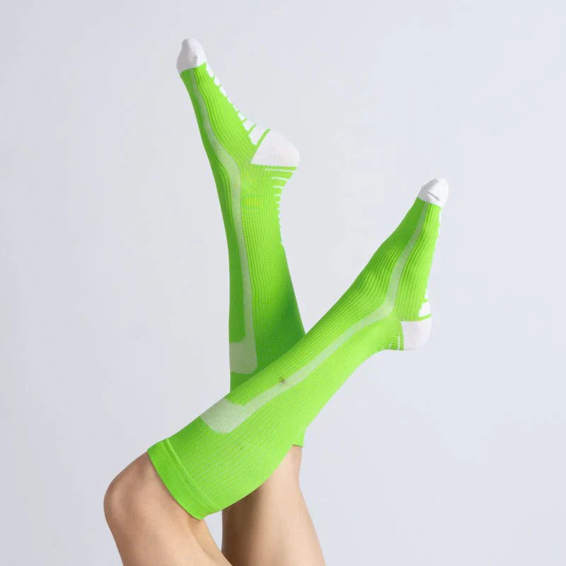 Close-up of a green and white gentle compression sock, highlighting the soft fabric and supportive design.