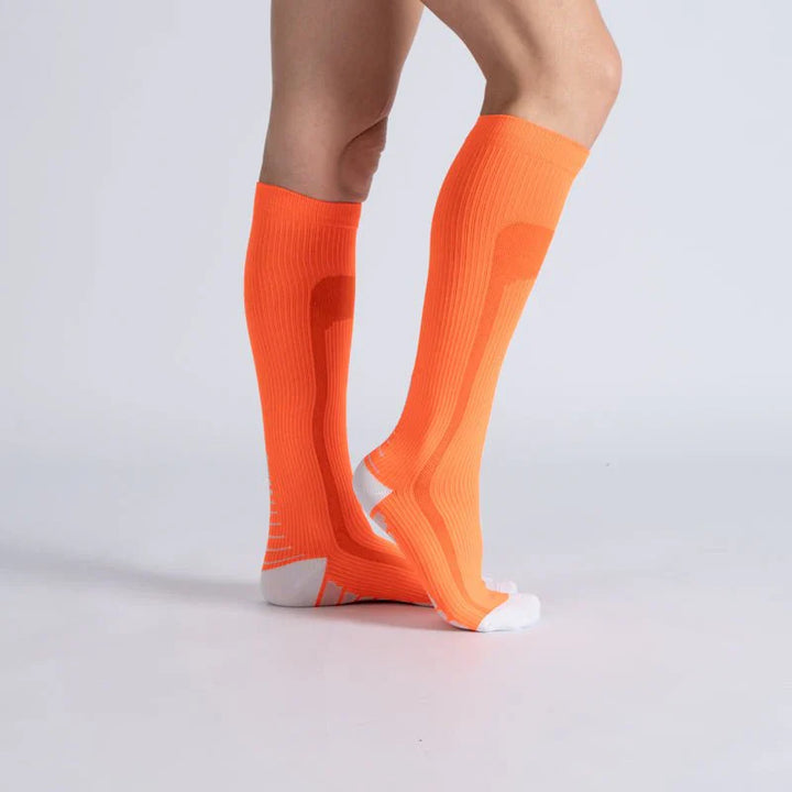 Close-up of orange-vanilla unisex compression socks, ideal for circulation and gentle support