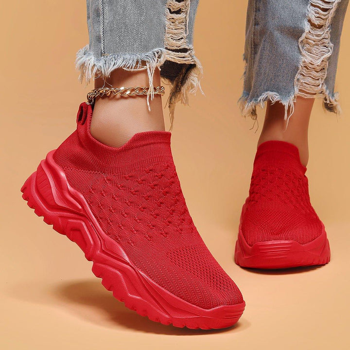 In-store display of several pairs of Red Rose Orthopedic Cloud Slip-On Shoes, nurse shoes