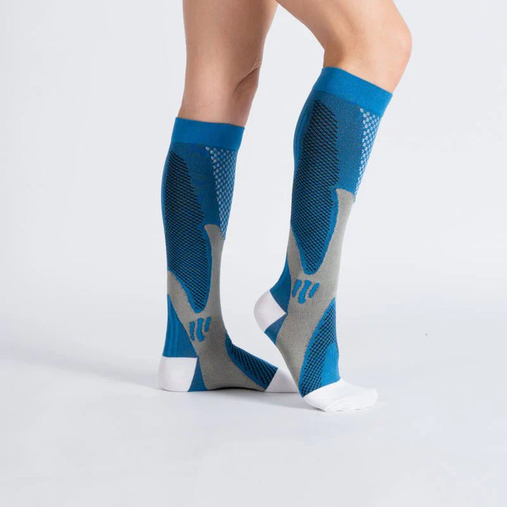 Unisex compression socks in royal blue (12-15mmHg) modeled on a leg, emphasizing daily wear comfort