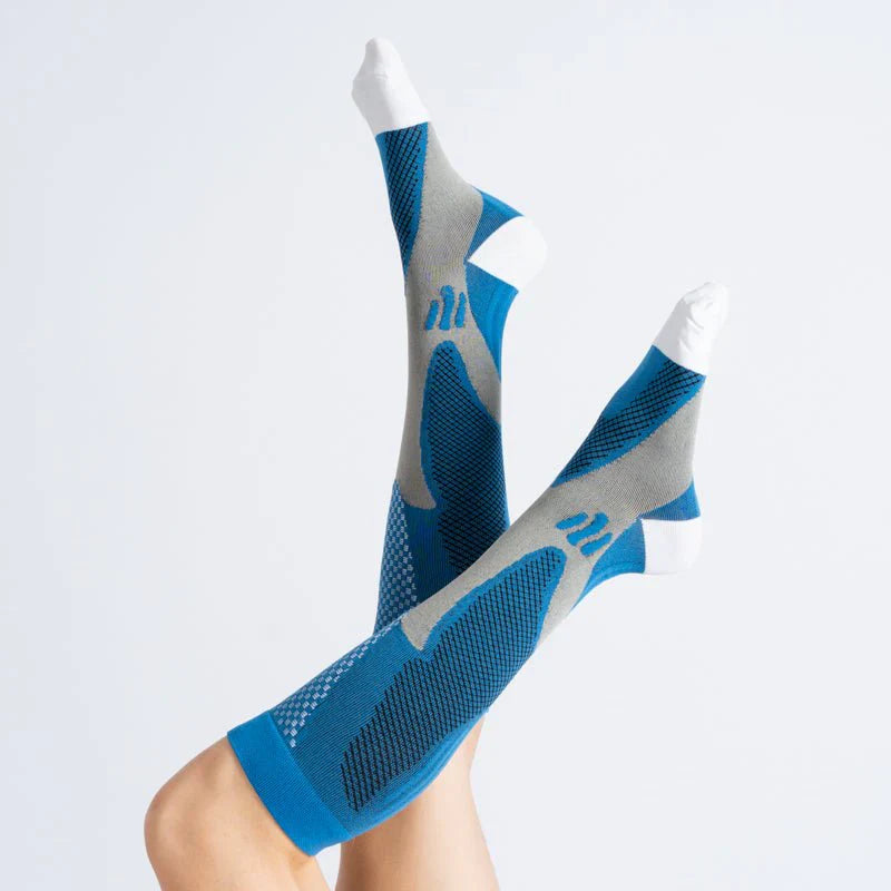 Folded pair of royal blue unisex compression socks (12-15mmHg) for leg health, ready for packaging