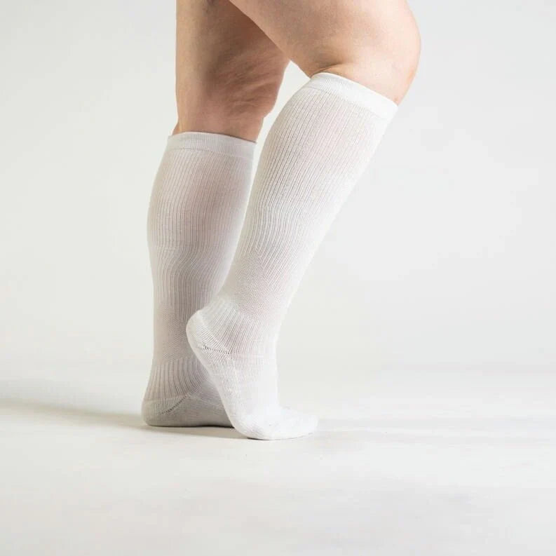 Pair of white gentle compression socks, designed for unisex comfort and leg support