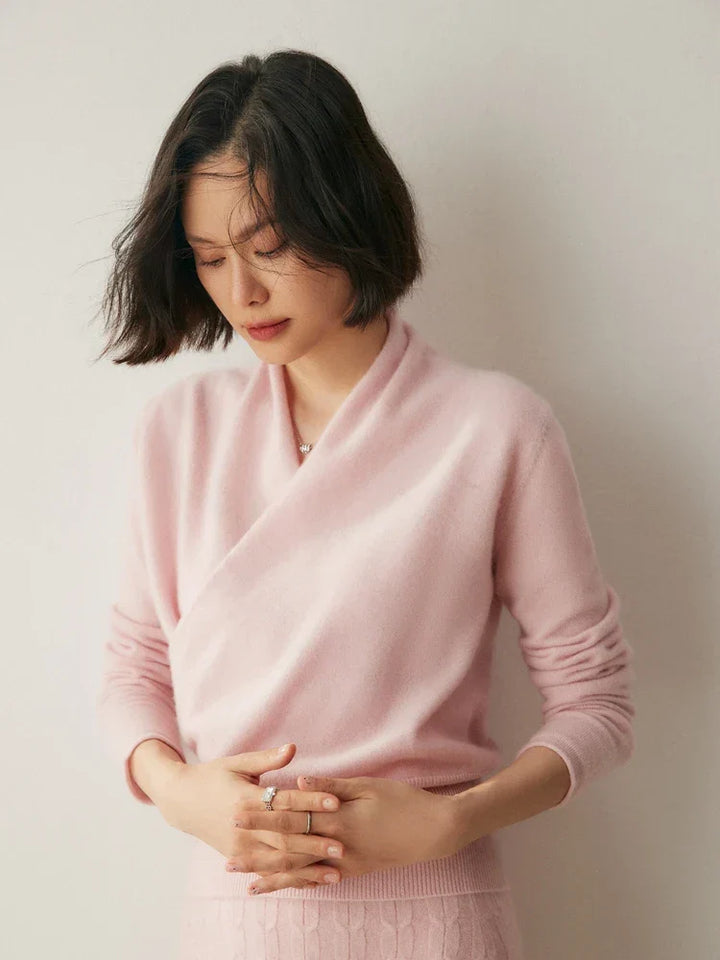 Woman wearing a luxurious red cashmere crossover sweater, elegant knitwear