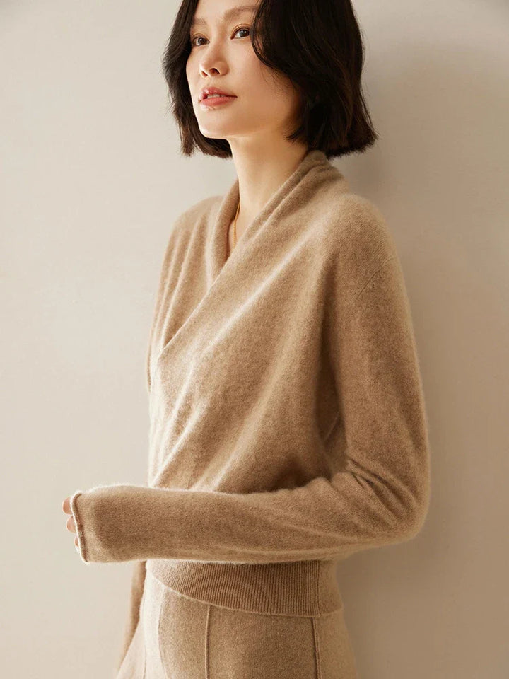 Back view of a woman in an ivory cashmere crossover sweater, elegant