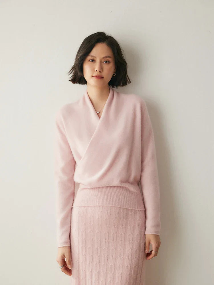 Woman posing in a warm pink cashmere crossover sweater, premium knitwear