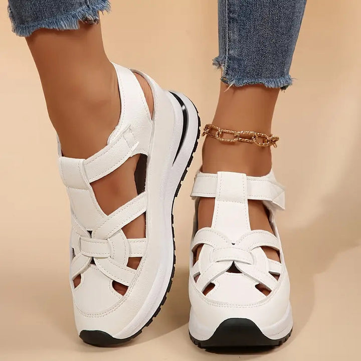 Sporty women's flatform sandals with stylish cutout details and a secure adjustable ankle strap.