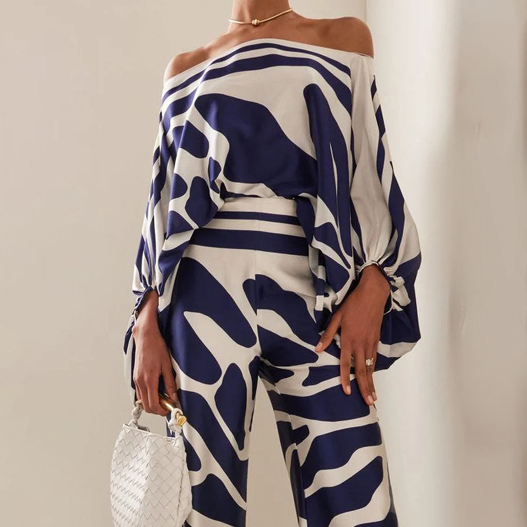 Comfortable women's two-piece pants set with artistic print. One-shoulder top & wide leg for elegant casual.