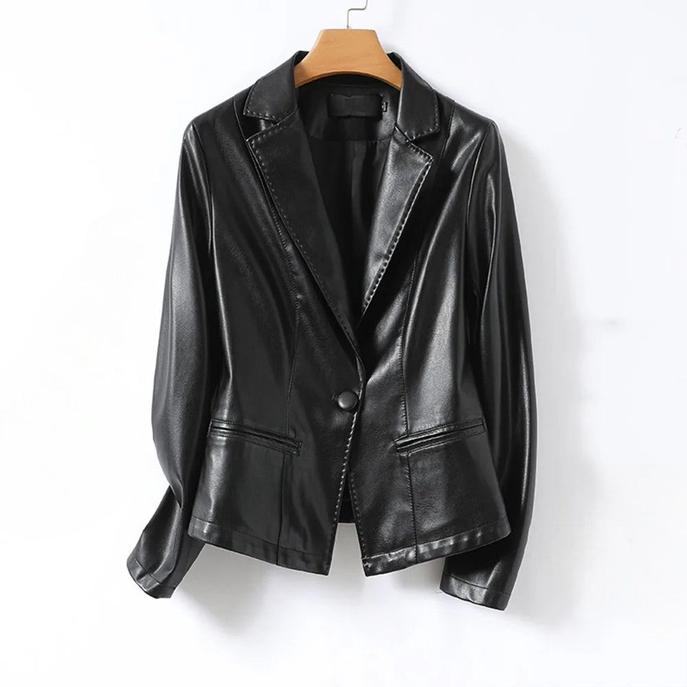 Close-up of a women's black faux leather blazer, showing the texture and tailored details.