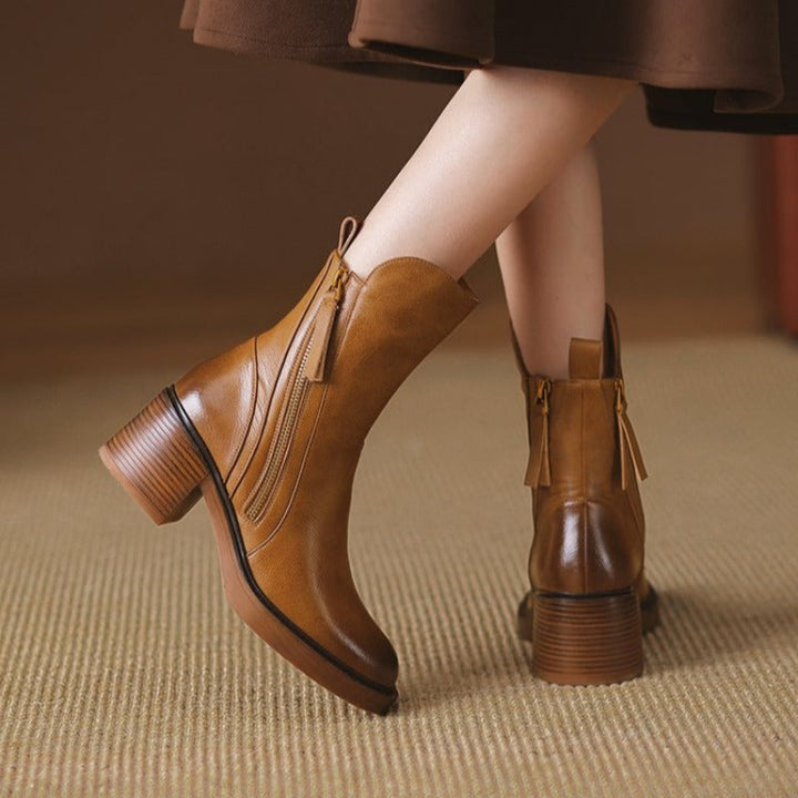 Stylish women's zip-up leather ankle boots with comfortable block heel, perfect for everyday wear