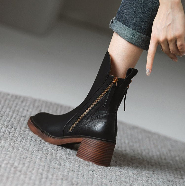Model wearing women's leather ankle boots with a zip, styled for a chic autumn outfit, footwear