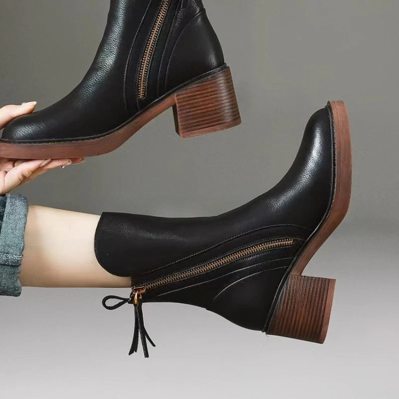 High-angle view of women's leather zip ankle boots, showing the footwear's full design and shape