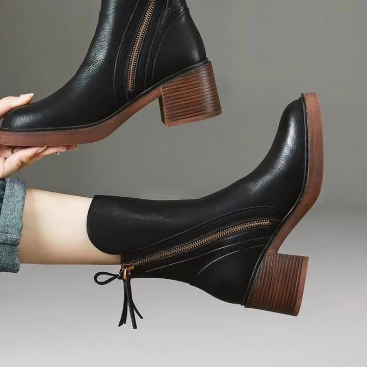 High-angle view of women's leather zip ankle boots, showing the footwear's full design and shape