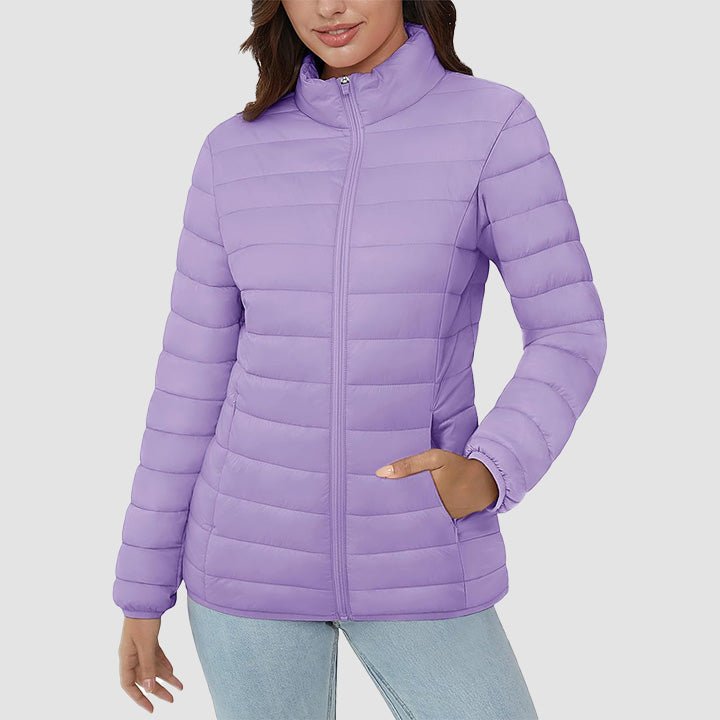 Foldable women's lightweight quilted puffer jacket, highlighting its packability for travel.