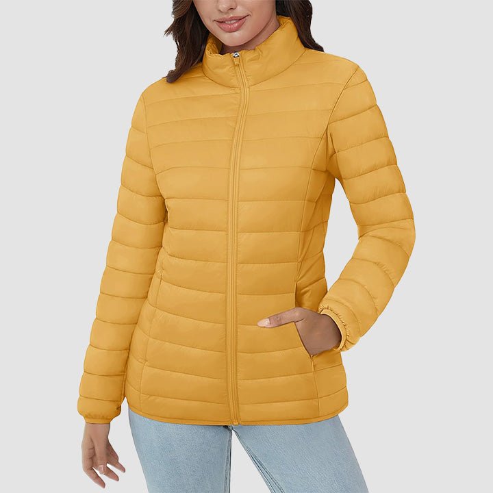 Women's lightweight quilted puffer jacket in a serene forest setting, embodying outdoor everyday wear.